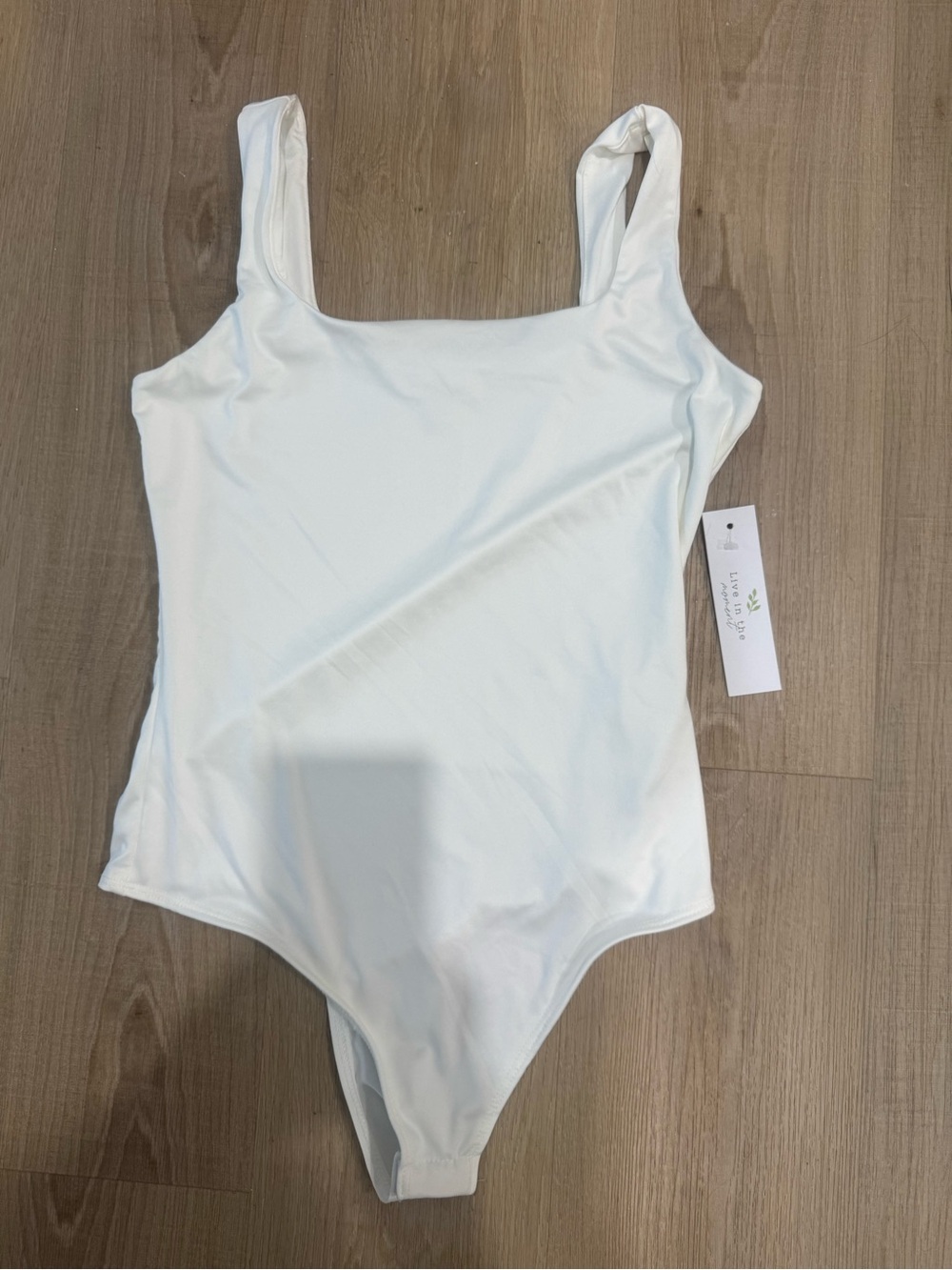Women’s creamy white body suit. Snaps are bottom